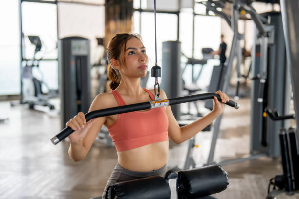 istock Focused Woman Working Out at a Gym Machine 2121740032