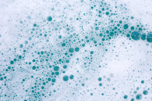 istock Detergent foam bubble on water. Blue background, Soap sud 2121762981