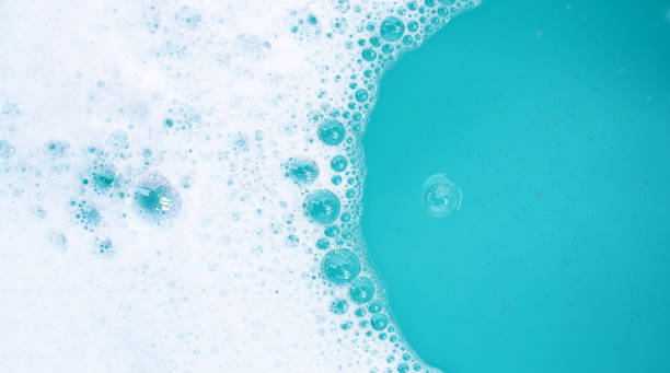 istock Detergent foam bubble on water. Blue background, Soap sud 2121765370
