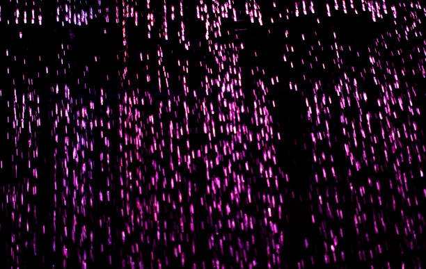 istock Drops of pink rain on a black background 2121766404