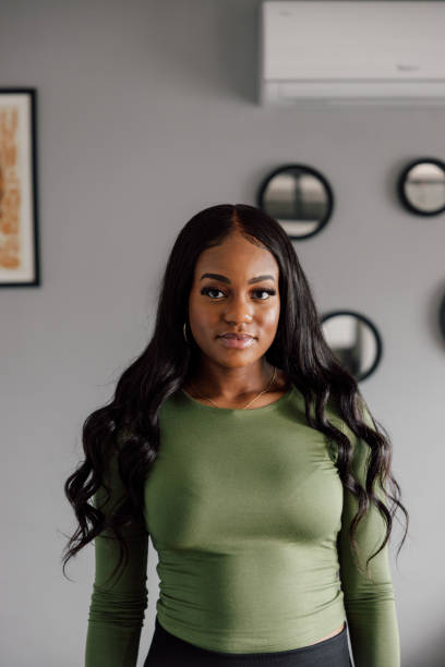 istock Young woman smiling and looking at camera 2121779283
