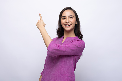 Portrait of Indian young woman wearing casual kurta on white background