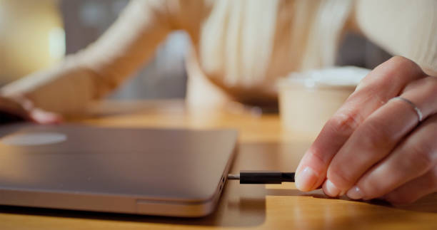istock Woman connecting laptop charger 2121843949