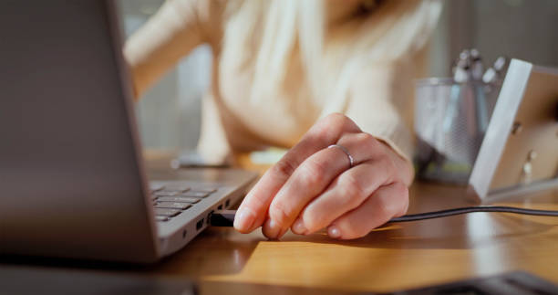 istock Woman connecting laptop charger 2121843950