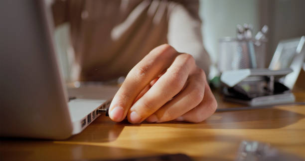 istock Man connecting laptop charger 2121843952