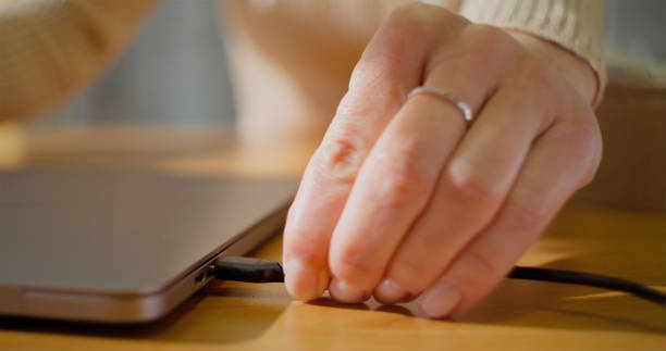 istock Woman connecting laptop charger 2121843967