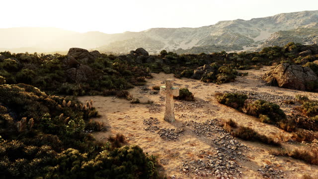 A solitary stone cross standing in the barren desert landscape