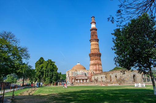 Delhi, India - March 10 2024: The Qutub Minar at Delhi India. The height of Qutub Minar is 72.5 meters, making it the tallest minaret in the world built of bricks.