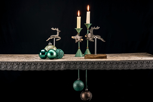 The Christmas decorative elements in warm turquoise tones against a dark background, creating a Christmassy atmosphere