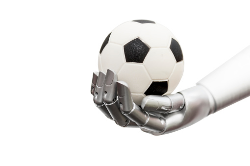 A machine hands the soccer ball, a robot hand with a small soccer ball