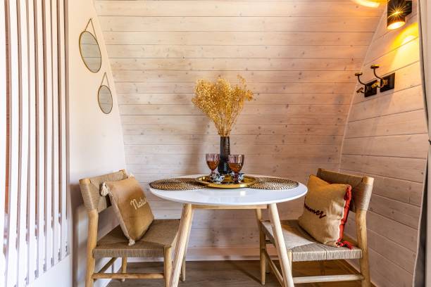 istock a small table with some chairs and plates on it and lights 2121939765