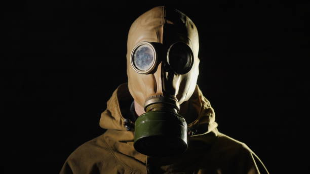 istock A person in a gas mask on a black background 2121959593