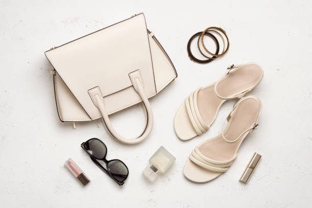 istock Hand bag, shoes and other small feminine accessory objects on abstract light textured background 2121978071
