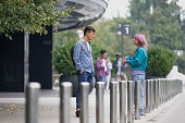 Two friends talking on footpath