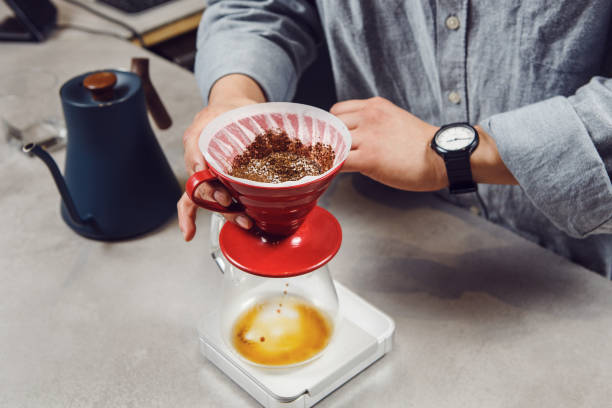 istock Expertly Brewing Single Cup of Pour-Over Coffee in Modern Cafe Setting 2122008314