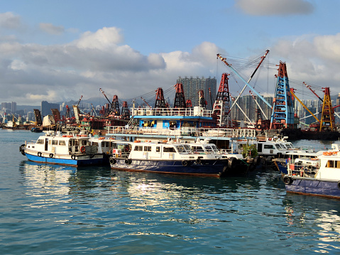 Boats moored in Hong Kong harbor, West Kowloon. Kowloon peninsula.
