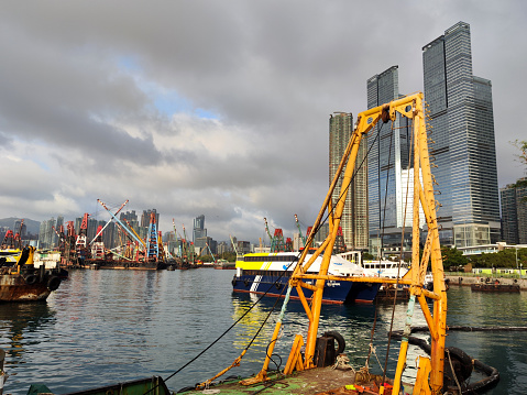 Boats moored in Hong Kong harbor, West Kowloon. Kowloon peninsula.