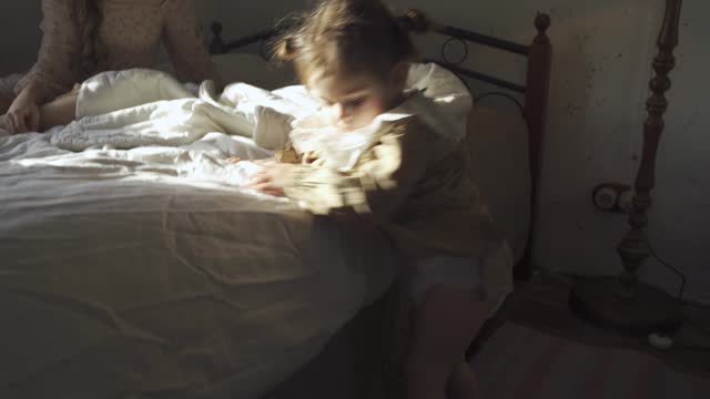 Woman Tending to a Child in a Rustic Bedroom Setting