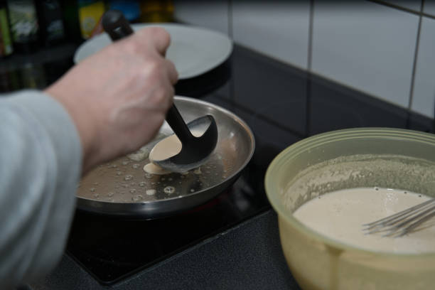 Pancake batter is poured into the pan using a ladle. production process