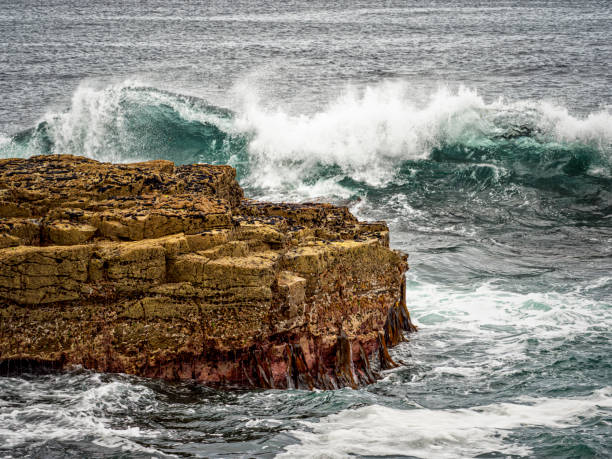 istock Waves Crashing Over Rock Formation 2122083924