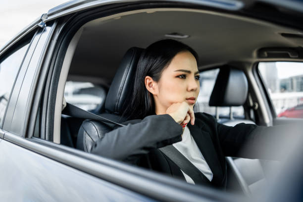 istock Driving during rush hour But the traffic is very congested. Angry face. Young asian businesswoman has broken down car on the road she feeling serious and stressed. Car crash Look for someone help. 2122087051