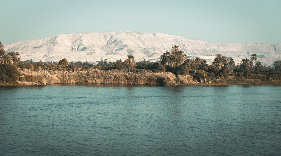 Nile landscape with snow-white desert hills in the background