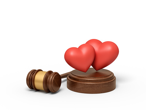 3d rendering of two cute red hearts on sounding block with judge gavel beside. Domestic relations law. Family court trial. Determine fates.