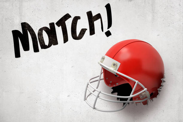 Stock photo of two football helmets going head to head