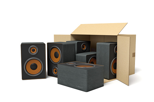 3d rendering of cardboard box lying sidelong with black audio speakers inside and three outside. Audio equipment. Stereo systems. Sound amplification.