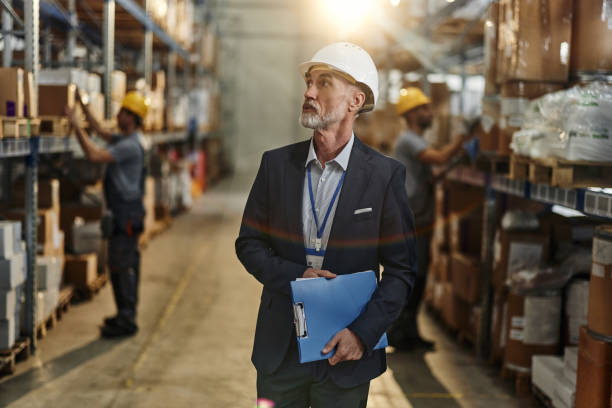 istock Mature male manager brainstorming in storage room. 2122120215