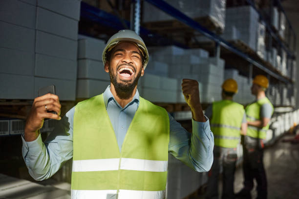 istock Cheerful black manager celebrating his success in storage room. 2122120747