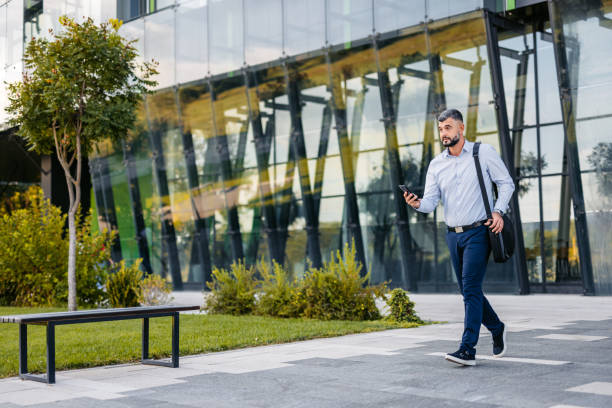 istock Mid-Adult Businessman Running Late For Work 2122144606