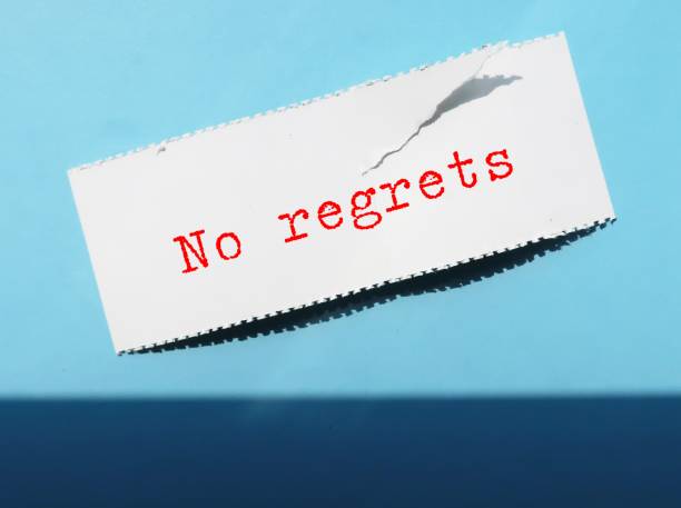 istock On blue background, torn paper with text written NO REGRET - to live a life without feeling bad about what you did in the past,  to a decision without feeling sorrow or remorse for 2122176916