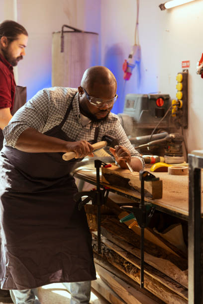 istock Artisan in woodworking workshop shaping wooden pieces 2122193952