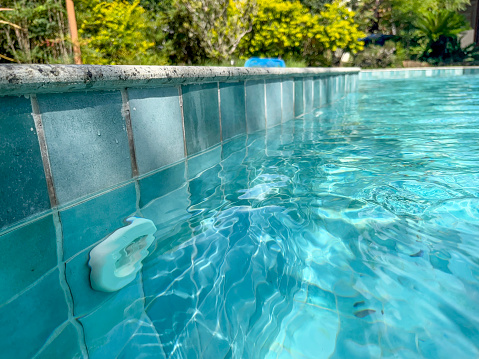 The edge of a hotel pool on a summer day. Empty space. Selective focus on the foreground. summer holiday concept