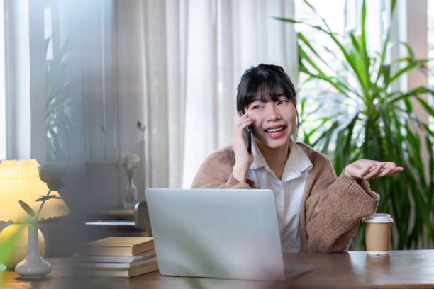 istock Young girl chatting with friends on the phone while taking online classes and doing online homework at home on a special holiday. 2122224664