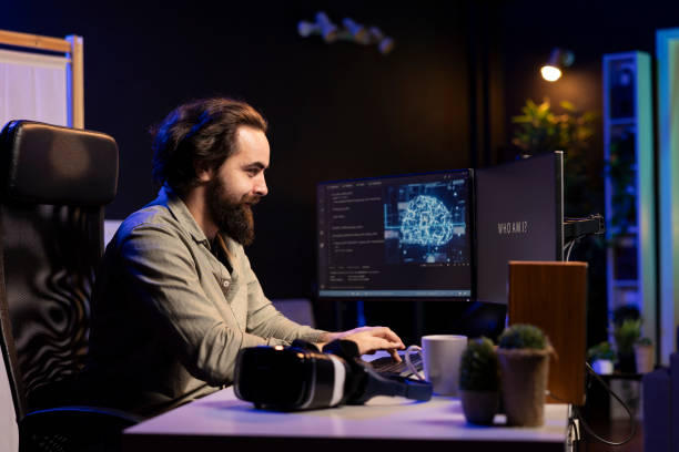 istock IT specialist smiling seeing AI becoming sentient, asking questions 2122259925