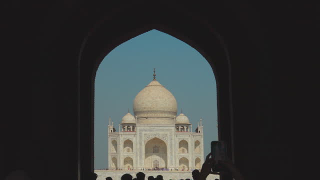 Agra, Uttar Pradesh, India. People visiting one of Seven world wonders - Fabulous Taj mahal. Famous indian islamic heritage at sunny day. Popular Place. People walking near Great Gate