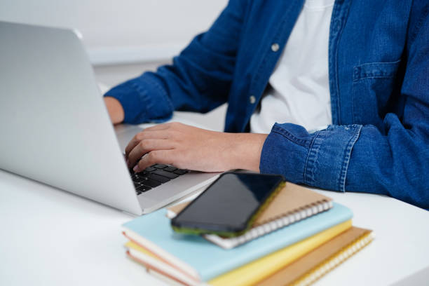 istock Asian teenage student write homework with laptop computer, learning university education concept. 2122275564
