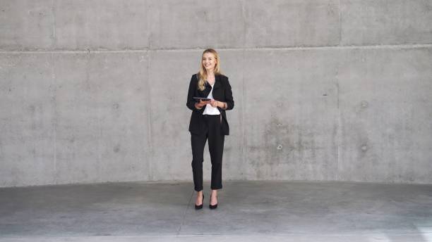 istock Confident Businesswoman Standing with Tablet in Modern Office 2122279757
