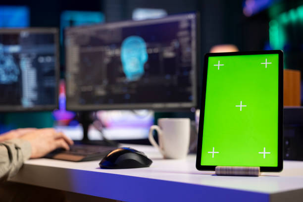 istock Green screen laptop next to programmer in home office staggered by sentient AI 2122279760