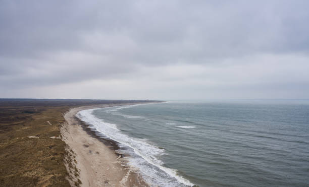 Aerial view of beautiful seascape and limestone cliff under cloudscape at beach in Frøstrup, Denmark