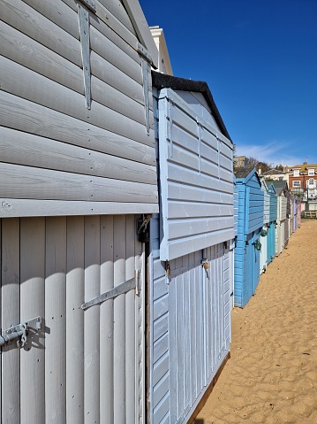 Bright, colorful beach huts on sandy beach on the Kentish coast, Kent, UK
