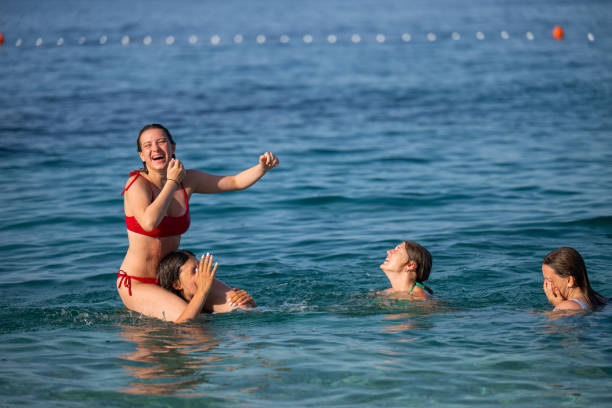 istock Young girls having fun in the sea 2122306897