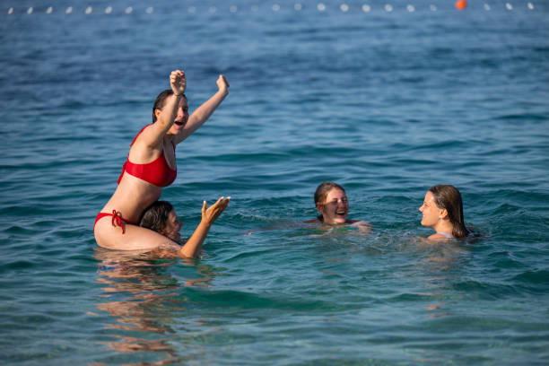 istock Young girls having fun in the sea 2122307913