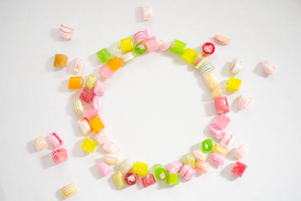A small bowl with colorful gummies. Chewing gummies for kids.