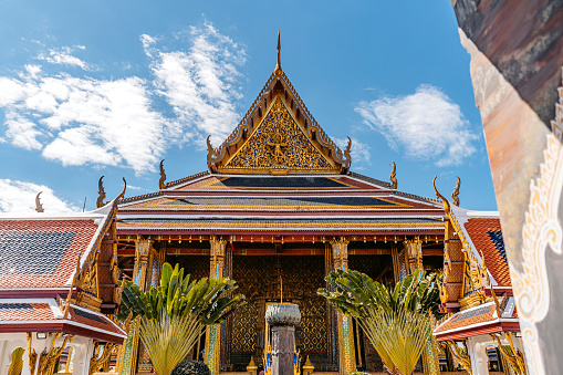The windows of popular Thai temples are decorated with gold paint and various patterns created from wood carvings.