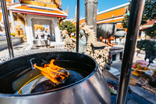 Incense burning at the Wat Phra Kaew Complex (The Temple Of The Emerald Buddha) in Bangkok in Thailand.