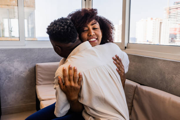 istock Young couple embracing at home 2122351032