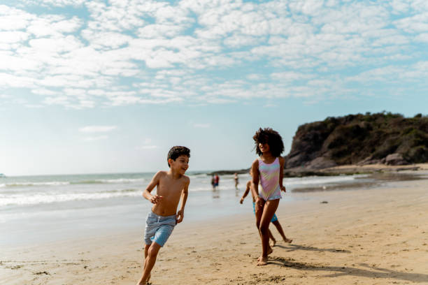 istock Friends children playing on the beach 2122361498